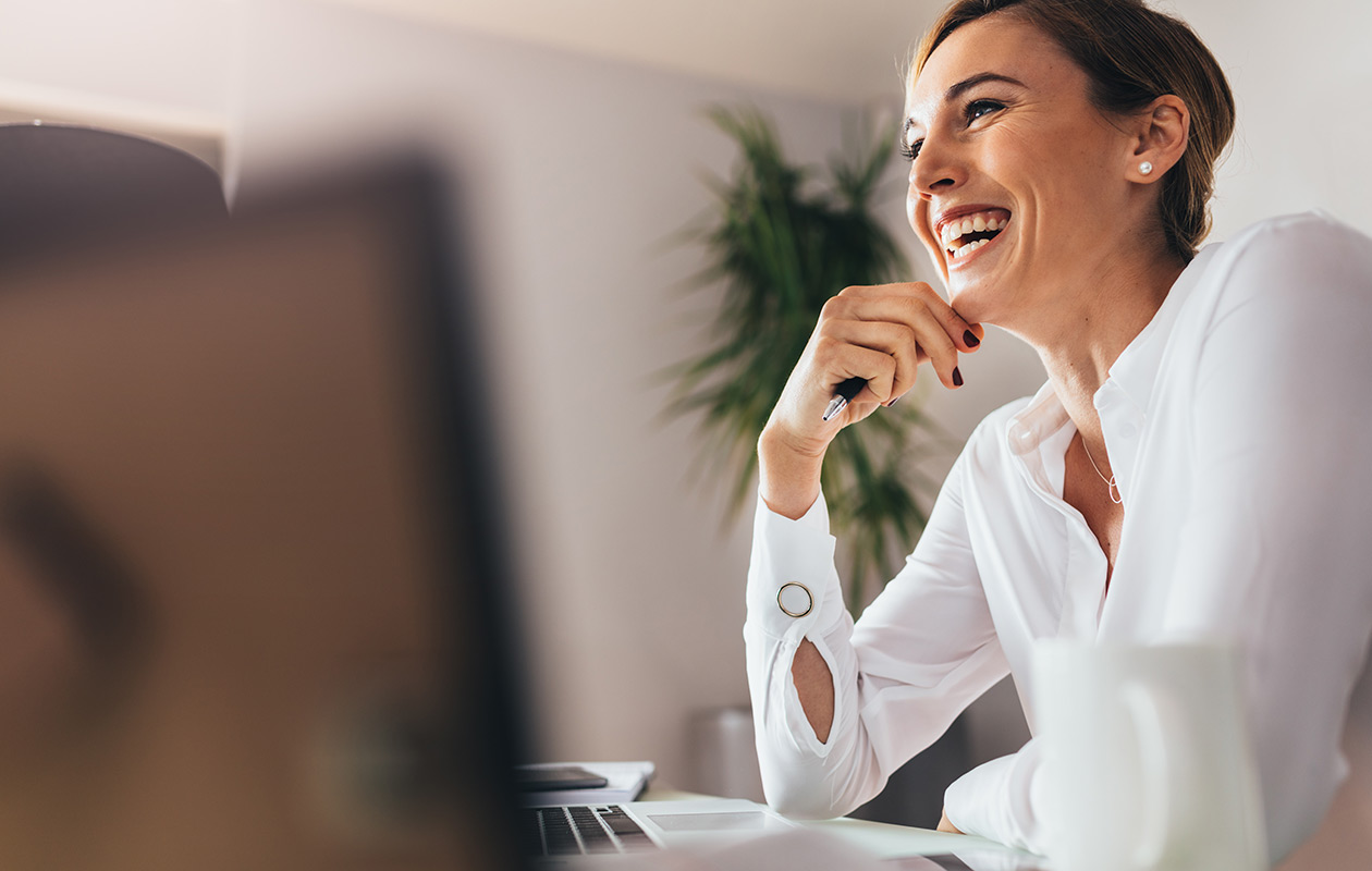 Professional woman smiling at her desk