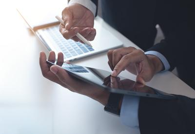 Two business professionals working on a tablet