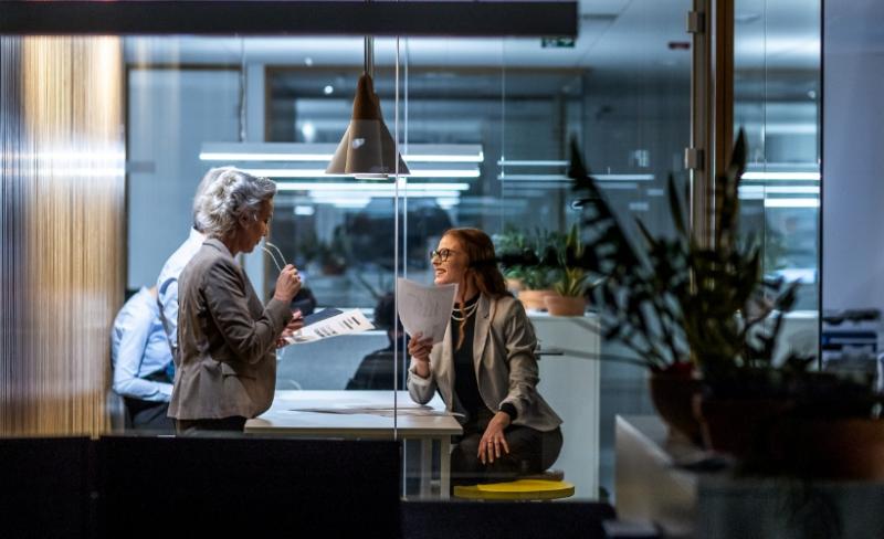 Financial professionals having a meeting in a glass conference room