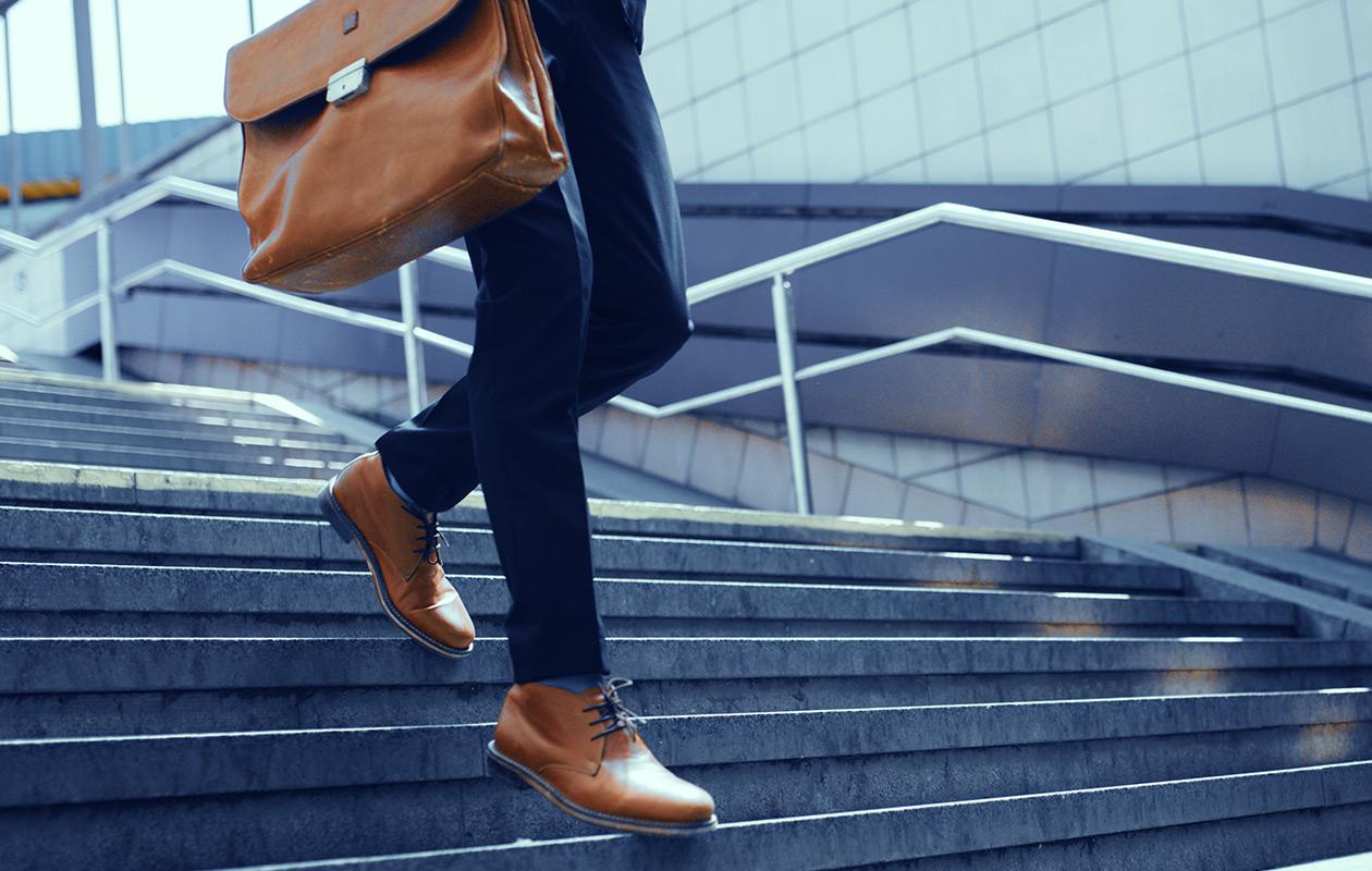 Business professional walking down outdoor stairs
