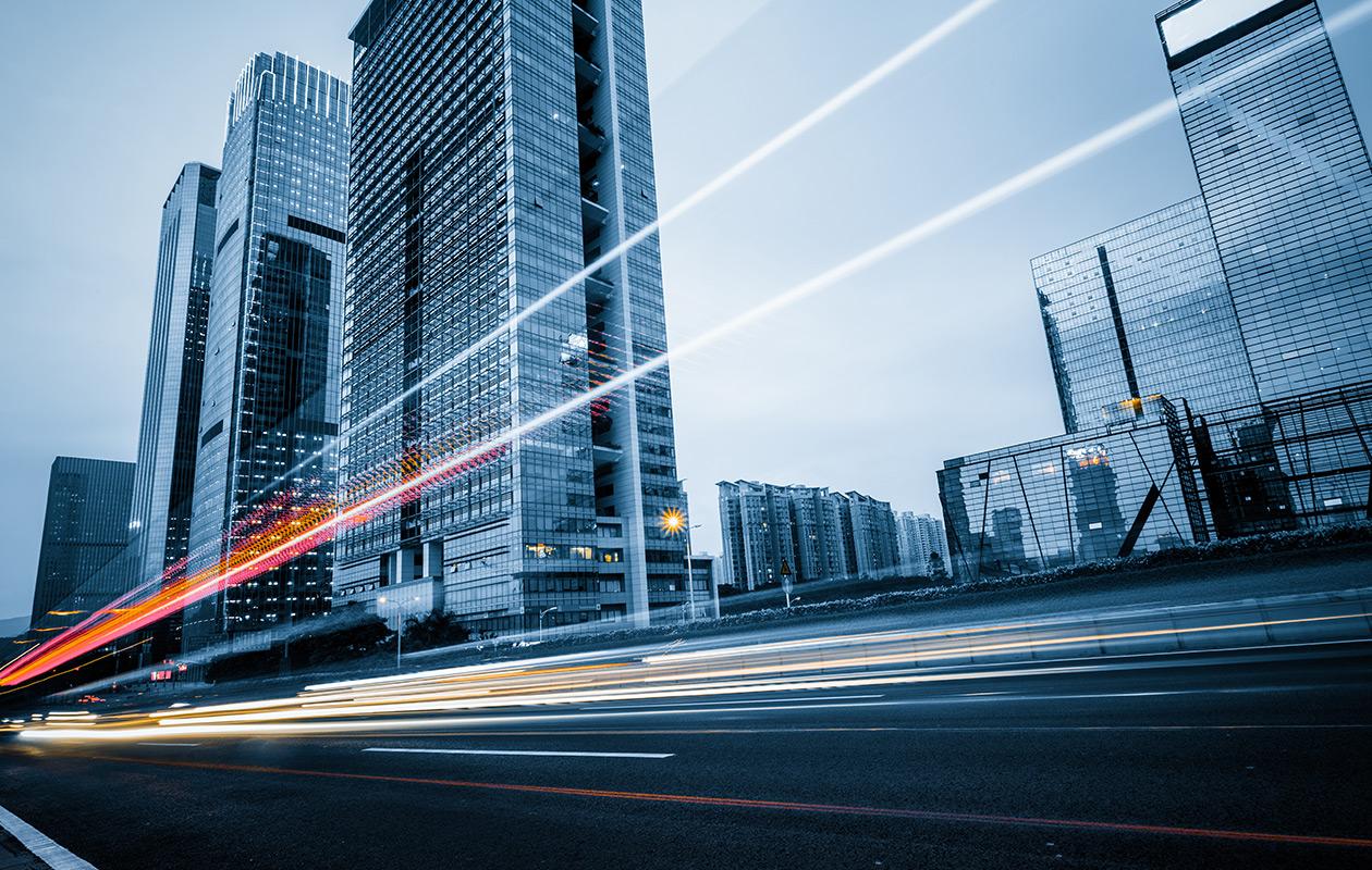 Time lapse photo of a city street with car lights streaking