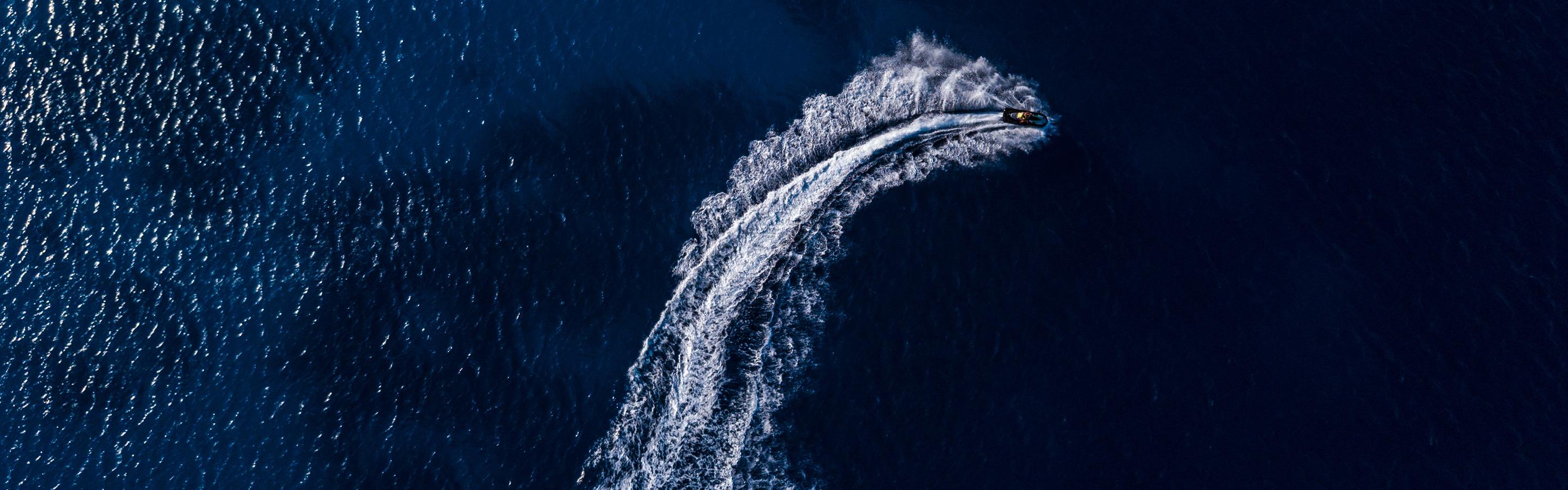 Bird eye view of a boat in deep blue water