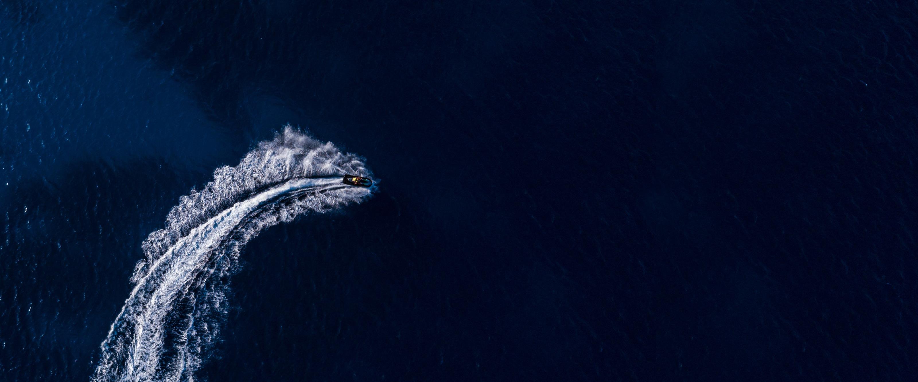 Boat moving quickly through open water
