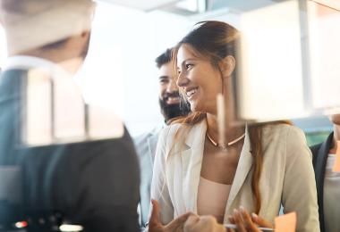 Professional woman in a casual meeting laughing